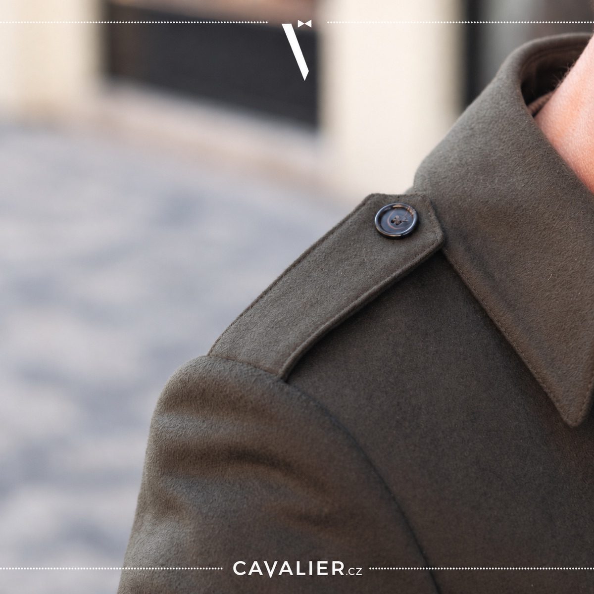 Close-up of the shoulder and epaulette on an olive made-to-measure men's coat
