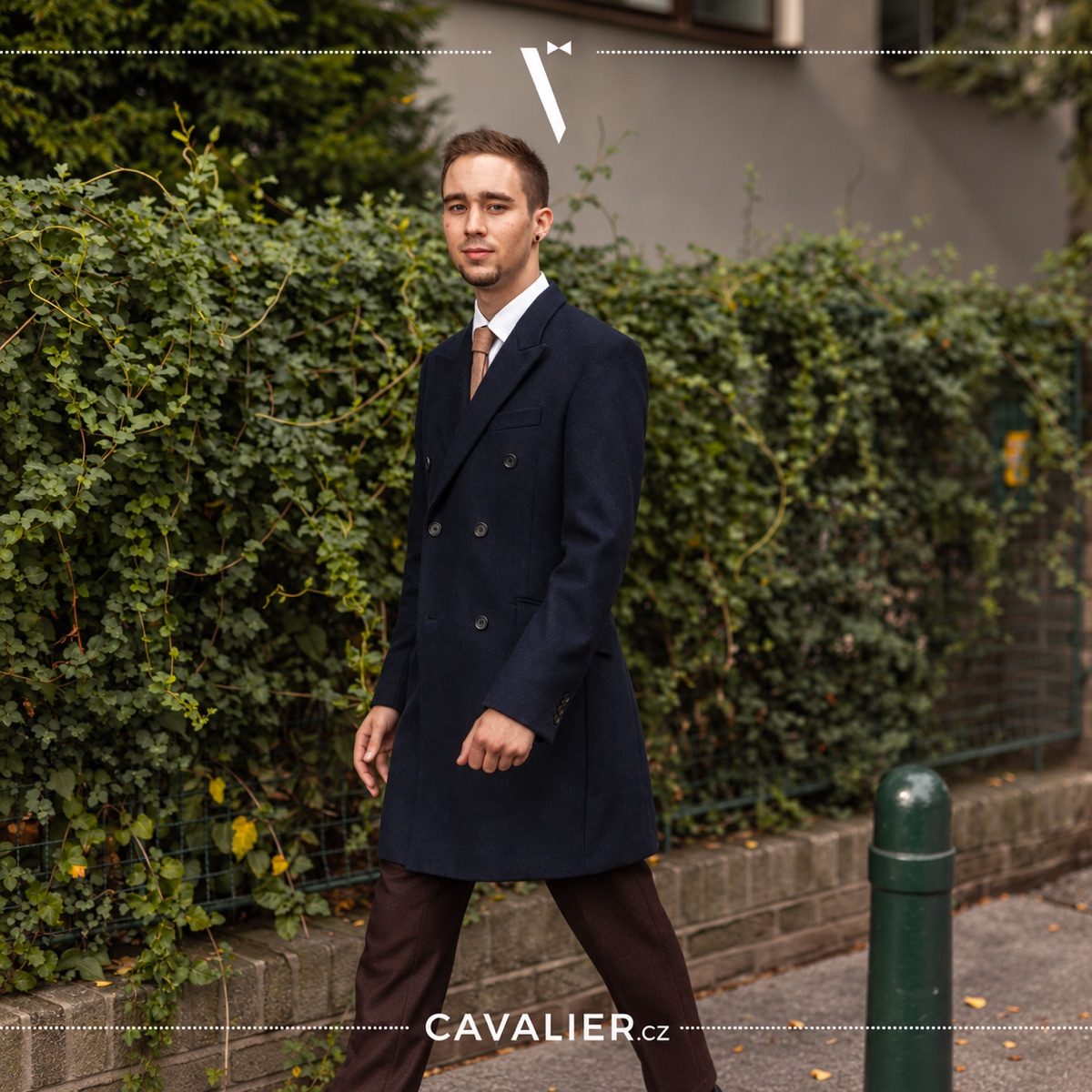 Dark blue double-breasted made-to-measure coat in modern man's city outfit.