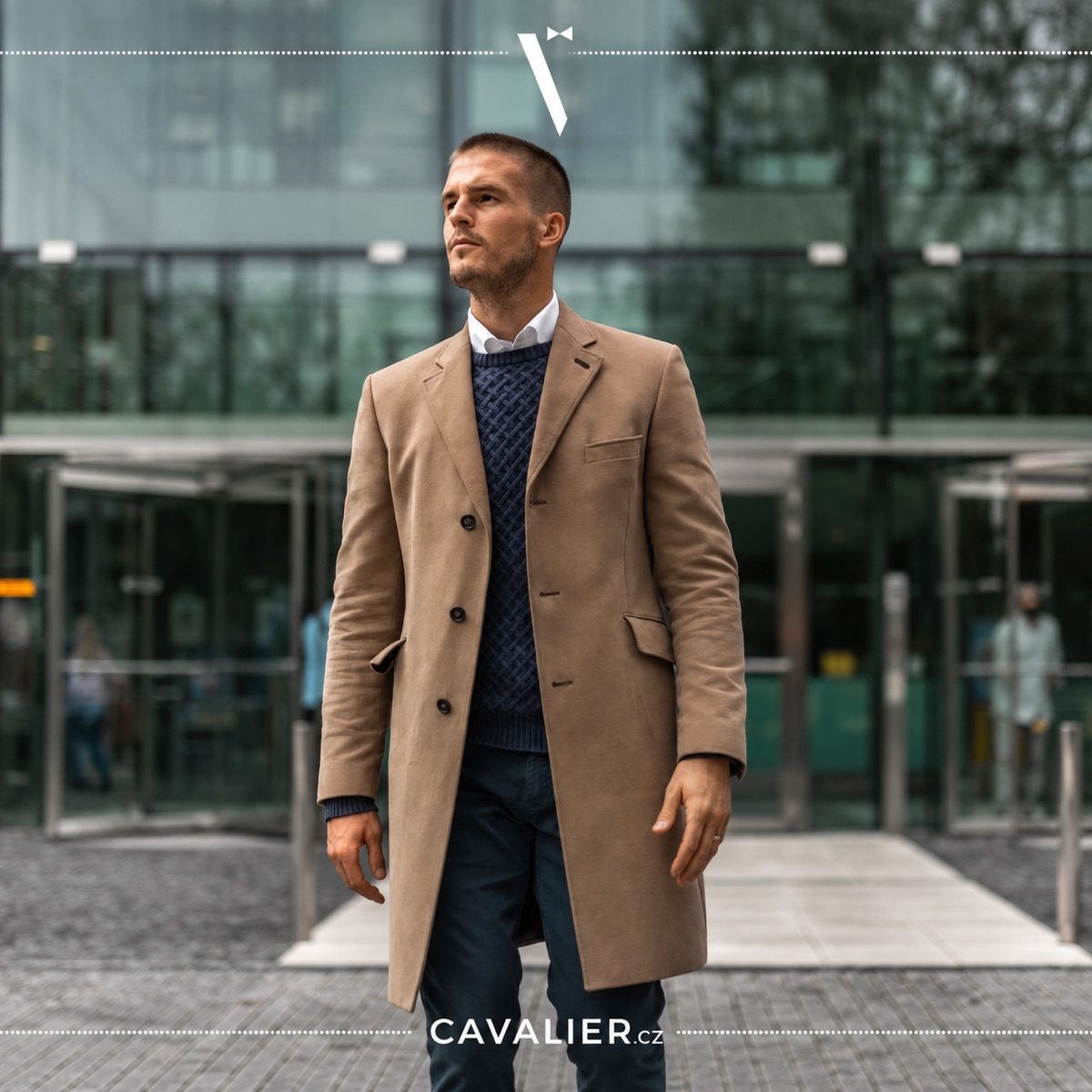 A man in a camel-coloured made-to-measure coat and knitwear, styled for smart casual wear