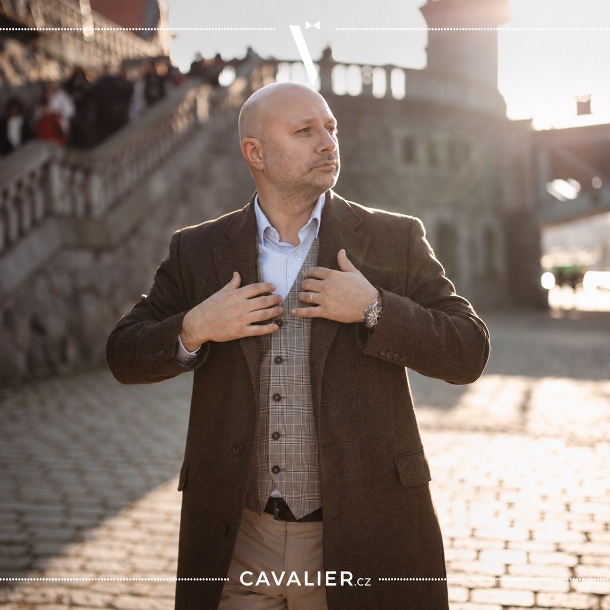 Detail of brown coat made to measure, leather watch and men's smart casual outfit.