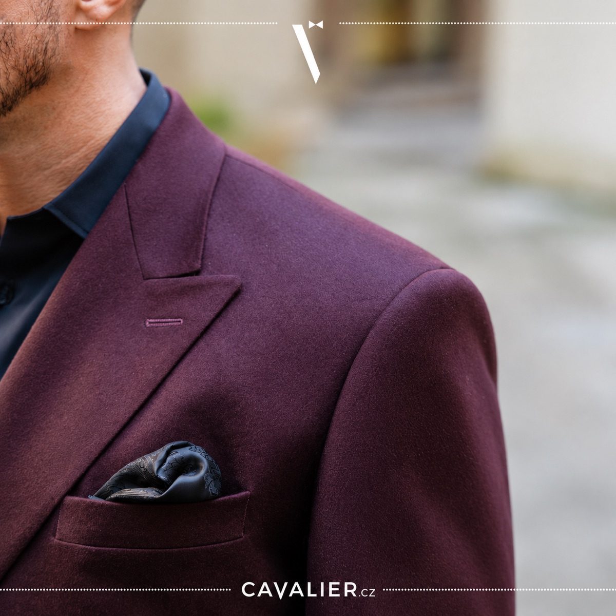 Close-up of the lapel, shoulder and breast pocket on a burgundy made-to-measure jacket