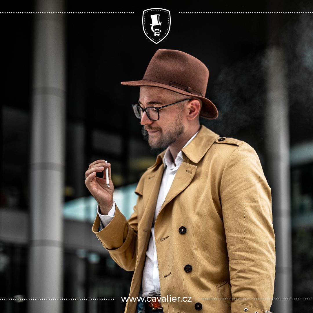 Article cover about trench coats: a man in a tan trench coat and hat.