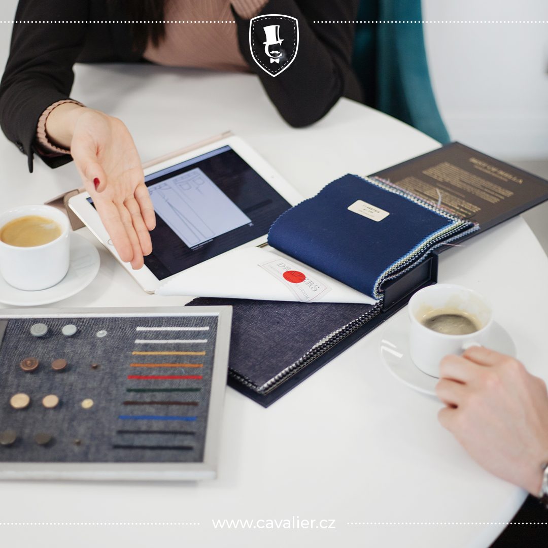 Fabric and button samples beside a tablet during a consultation