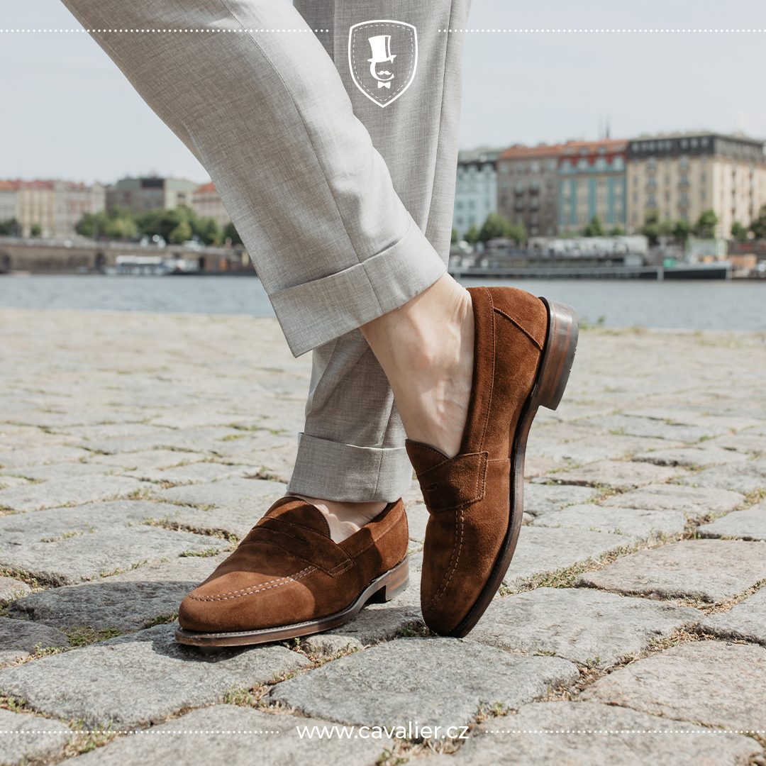 Brown suede loafers with light made-to-measure trousers cuffed above the ankle