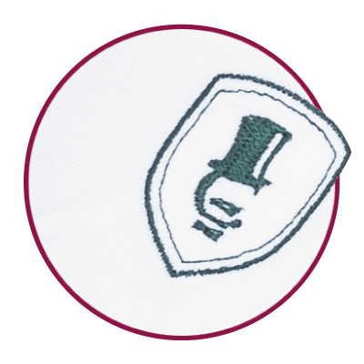 Embroidered emblem on white blouse fabric.