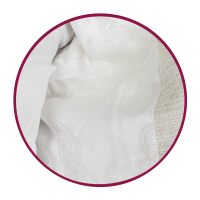 Close-up of textured white fabric on a women’s jacket.