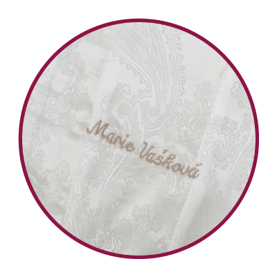 Name embroidered on a light-coloured lining.