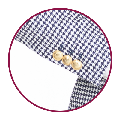 Gold buttons on a patterned women's jacket sleeve.
