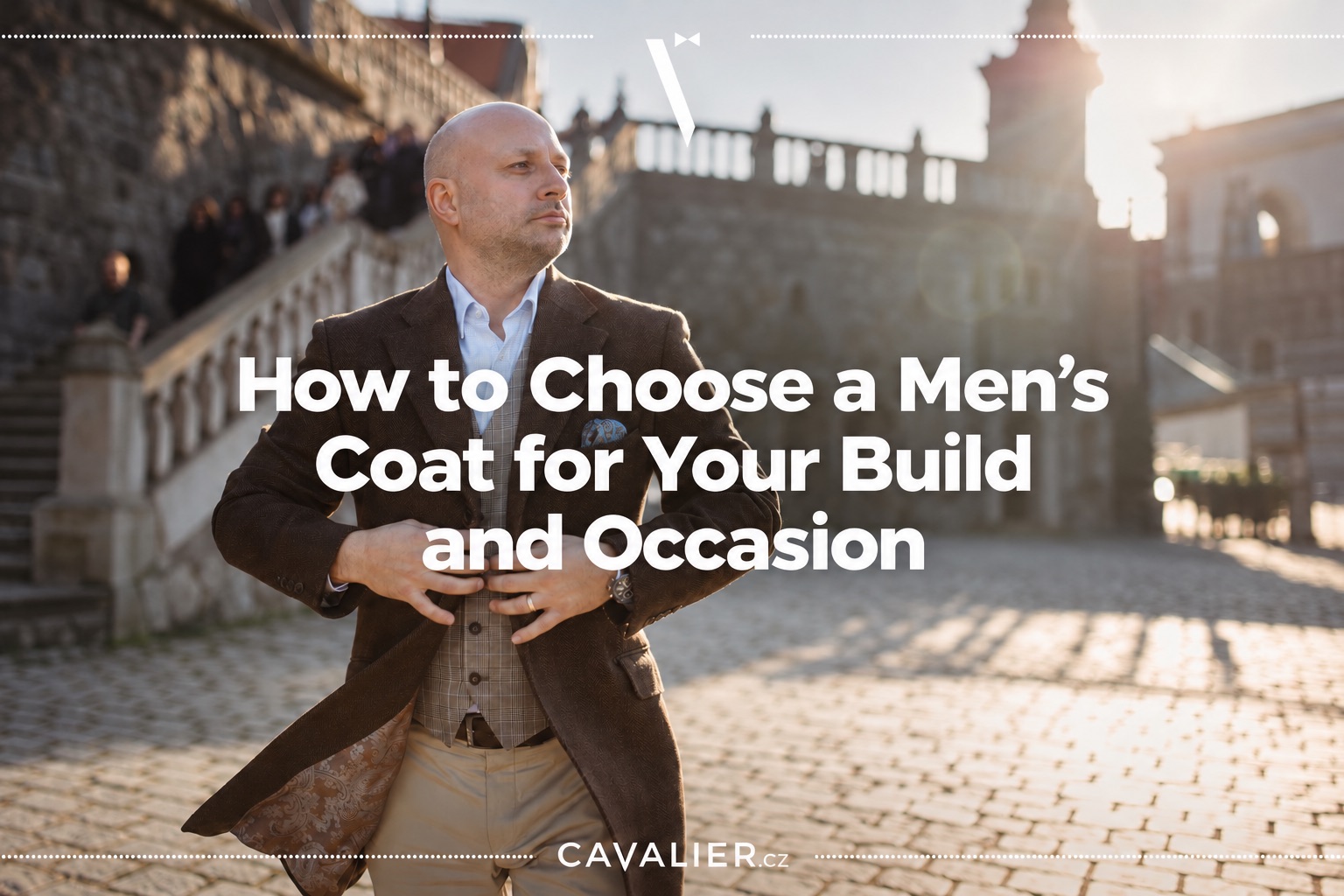 Man wearing a brown coat over a checked waistcoat outdoors.
